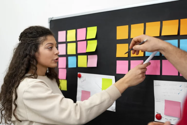 side-view-people-discussing-with-post-its-scaled